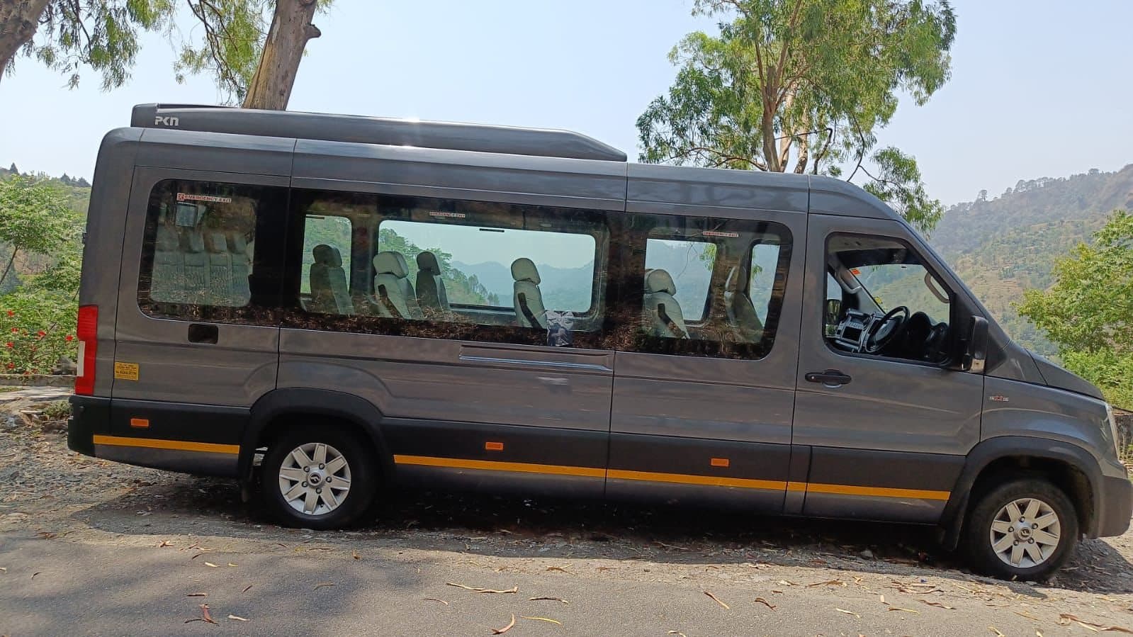A ConfirmBus Force Urbania parked on a hill road