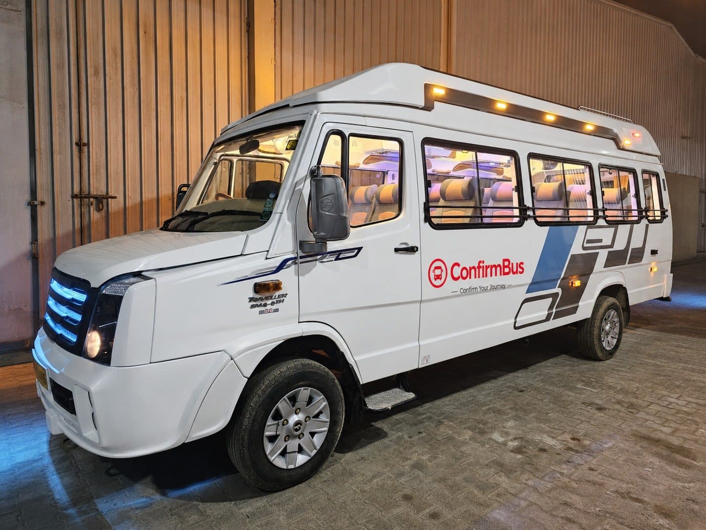 A ConfirmBus branded Tempo Traveller